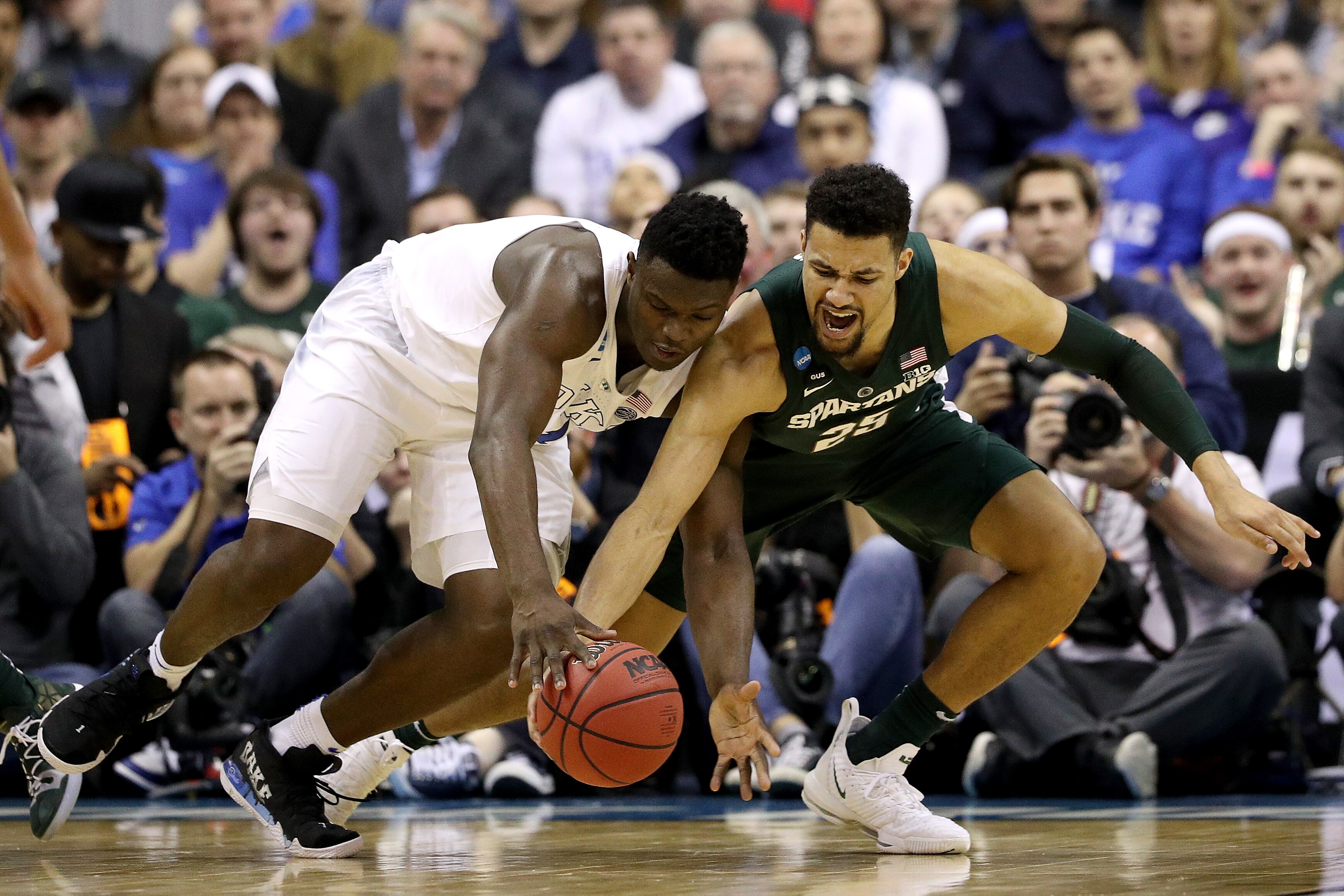 WASHINGTON, DC - MARCH 31:  Zion Williamson #1 of the Duke Blue Devils and Kenny Goins #25 of the Michigan State Spartans battle for the ball during the first half in the East Regional game of the 2019 NCAA Men's Basketball Tournament at Capital One Arena on March 31, 2019 in Washington, DC. (Photo by Patrick Smith/Getty Images)