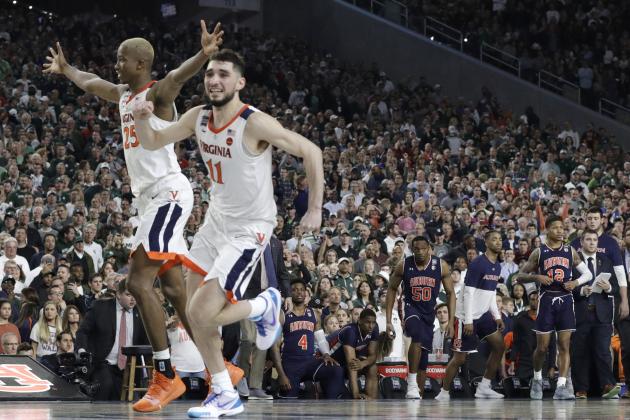 Virginia's Mamadi Diakite, left, and Ty Jerome celebrate at the end of a semifinal round game against Auburn in the Final Four NCAA college basketball tournament, Saturday, April 6, 2019, in Minneapolis. (AP Photo/David J. Phillip)