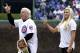 Retired professional wrestler Ric Flair, left, and his daughter Miss Charlotte, the current WWE champion stand on the field before throwing out a ceremonial first pitch before a baseball game between the Atlanta Braves and the Chicago Cubs Sunday, May 1, 2016, in Chicago. (AP Photo/Nam Y. Huh)