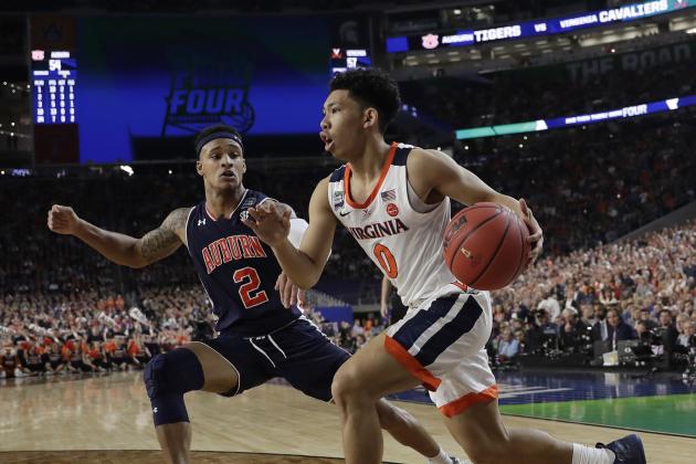 Virginia's Kihei Clark (0) drives against Auburn's Bryce Brown (2) during the second half in the semifinals of the Final Four NCAA college basketball tournament, Saturday, April 6, 2019, in Minneapolis. (AP Photo/David J. Phillip)