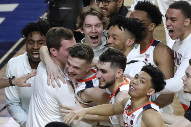 Virginia players celebrate in front of Auburn forward Danjel Purifoy (3) after a semifinal round game in the Final Four NCAA college basketball tournament, Saturday, April 6, 2019, in Minneapolis. (AP Photo/Matt York)
