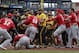 Cincinnati Reds' Yasiel Puig (66) pulls away from Tucker Barnhart (16) as he attempts to re-enter a bench clearing during the fourth inning of a baseball game against the Pittsburgh Pirates in Pittsburgh, Sunday, April 7, 2019. (AP Photo/Gene J. Puskar)