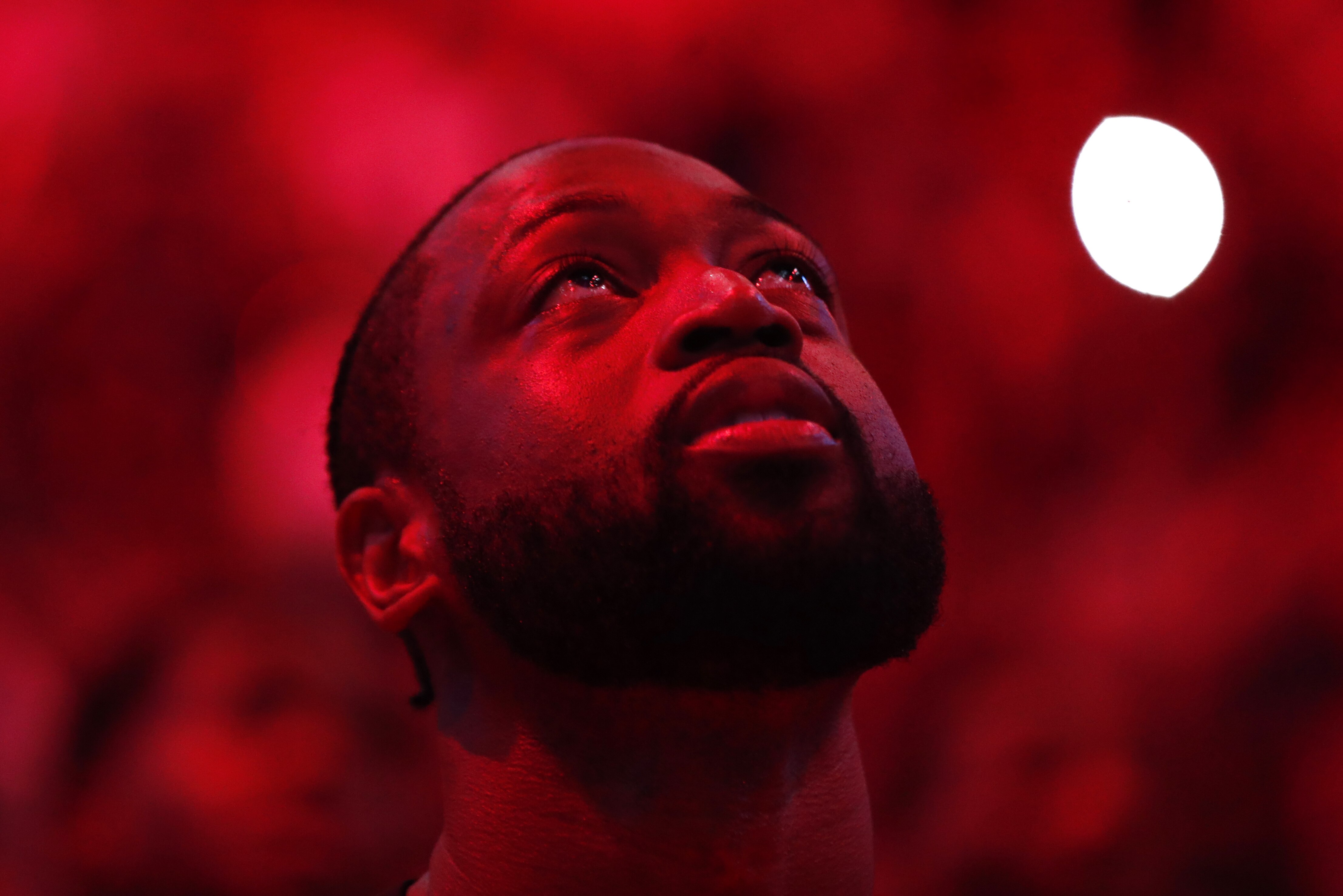 Miami Heat guard Dwyane Wade stands during a ceremony in his honor as he is playing his final home regular season game when the Heat host the Philadelphia 76ers, Tuesday, April 9, 2019, in Miami. Wade is retiring at the end of the season. (AP Photo/Brynn Anderson)