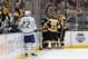 Boston Bruins players surround teammate Charlie Coyle after he scored a goal as Toronto Maple Leafs defenseman Nikita Zaitsev (22) looks on during the first period of Game 2 of an NHL hockey first-round playoff series, Saturday, April 13, 2019, in Boston. (AP Photo/Mary Schwalm)