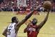 Houston Rockets guard Chris Paul (3) shoots as Utah Jazz forward Derrick Favors defends during the second half of Game 1 of an NBA basketball first-round playoff series, Sunday, April 14, 2019, in Houston. Houston won the game 122-90. (AP Photo/Eric Christian Smith)