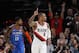 Portland Trail Blazers guard Damian Lillard, right, reacts after making a basket as Oklahoma City Thunder forward Paul George, left, trails the play during the first half of Game 1 of a first-round NBA basketball playoff series in Portland, Ore., Sunday, April 14, 2019. (AP Photo/Steve Dipaola)