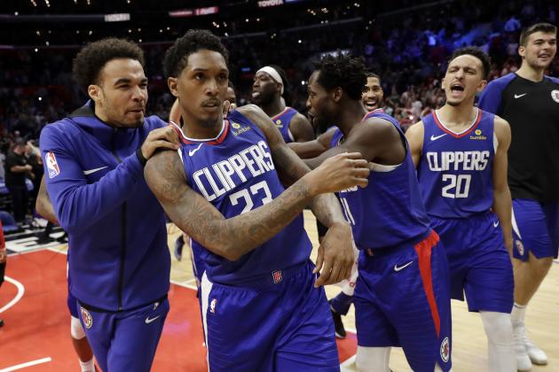 Los Angeles Clippers' Lou Williams (23) is mobbed by teammates after making the game-winning shot as time expired during the second half of an NBA basketball game against the Brooklyn Nets Sunday, March 17, 2019, in Los Angeles. (AP Photo/Marcio Jose Sanchez)