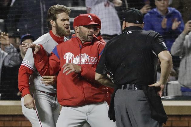 Philadelphia Phillies manager Gabe Kapler, center, restrains Bryce Harper, left, while arguing a call with umpire Mark Carlson during the fourth inning of a baseball game Monday, April 22, 2019, in New York. (AP Photo/Frank Franklin II)