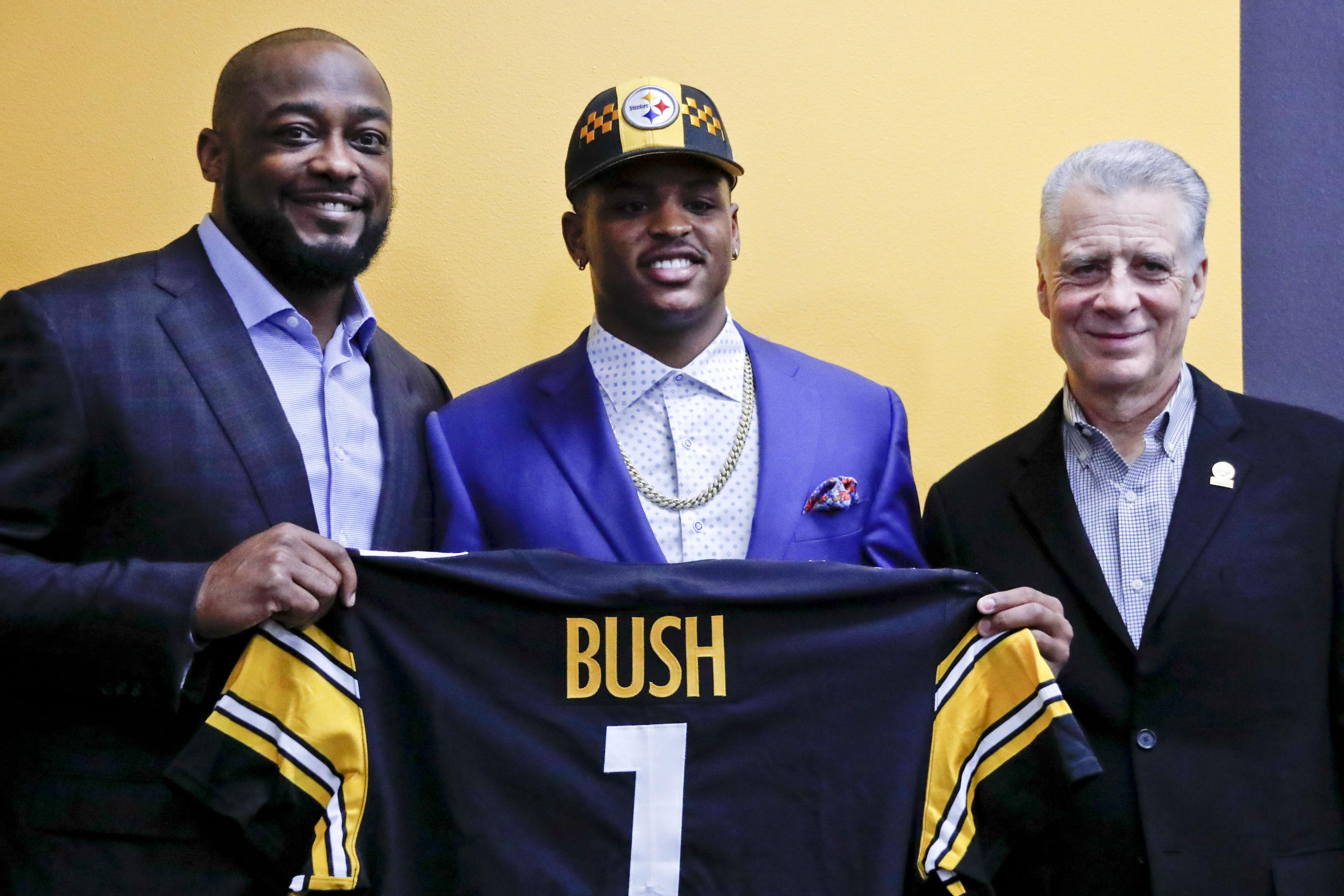 Pittsburgh Steelers linebacker Devin Bush signs his jersey to swap