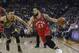 Toronto Raptors guard Fred VanVleet (23) drives to the basket against Golden State Warriors' Stephen Curry during the first half of an NBA basketball game in Oakland, Calif., Wednesday, Dec. 12, 2018. (AP Photo/Jeff Chiu)
