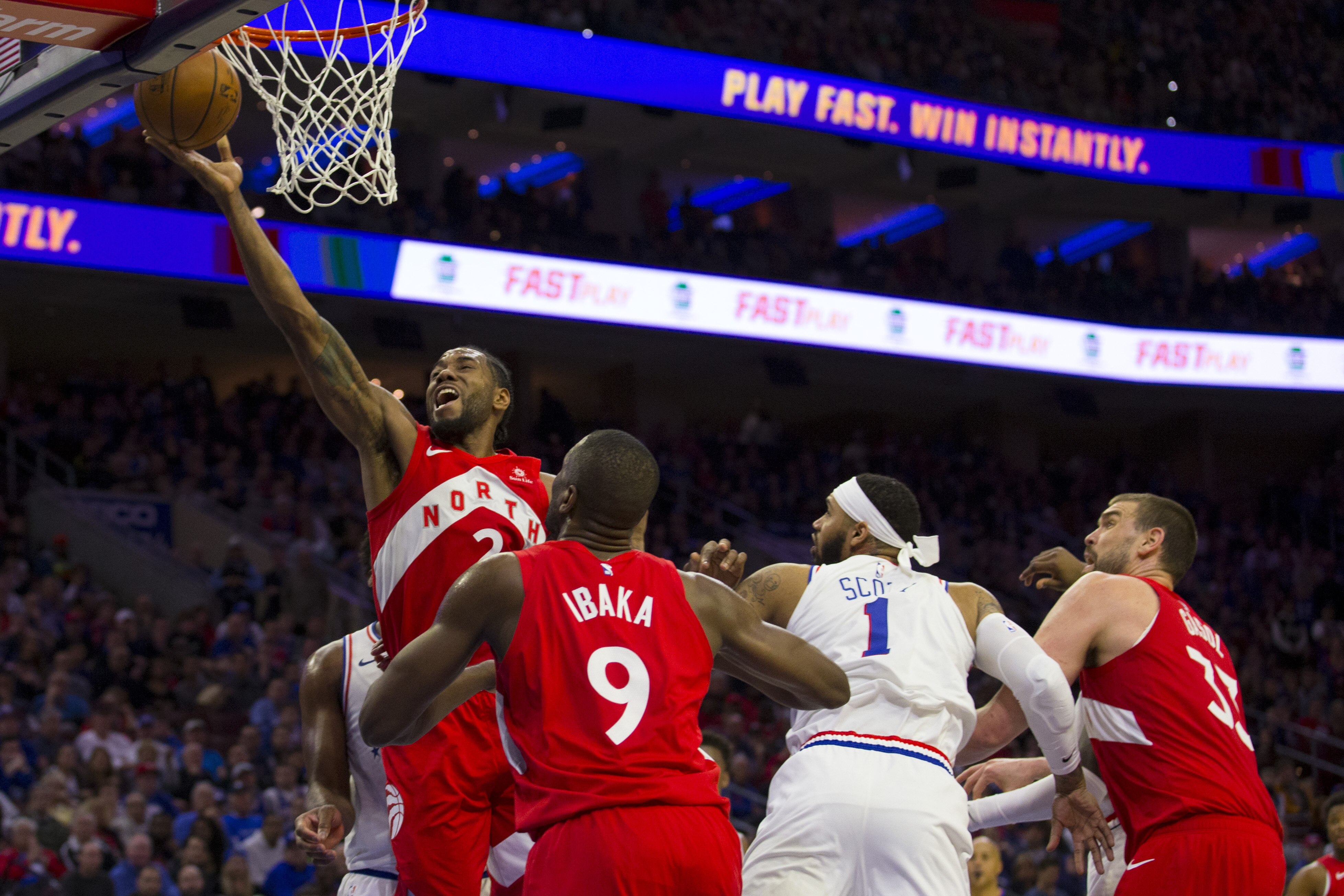 PHILADELPHIA, PA - MAY 05: Kawhi Leonard #2 of the Toronto Raptors attempts a layup past Mike Scott #1 of the Philadelphia 76ers in the second quarter of Game Four of the Eastern Conference Semifinals at the Wells Fargo Center on May 5, 2019 in Philadelphia, Pennsylvania. NOTE TO USER: User expressly acknowledges and agrees that, by downloading and or using this photograph, User is consenting to the terms and conditions of the Getty Images License Agreement. (Photo by Mitchell Leff/Getty Images)