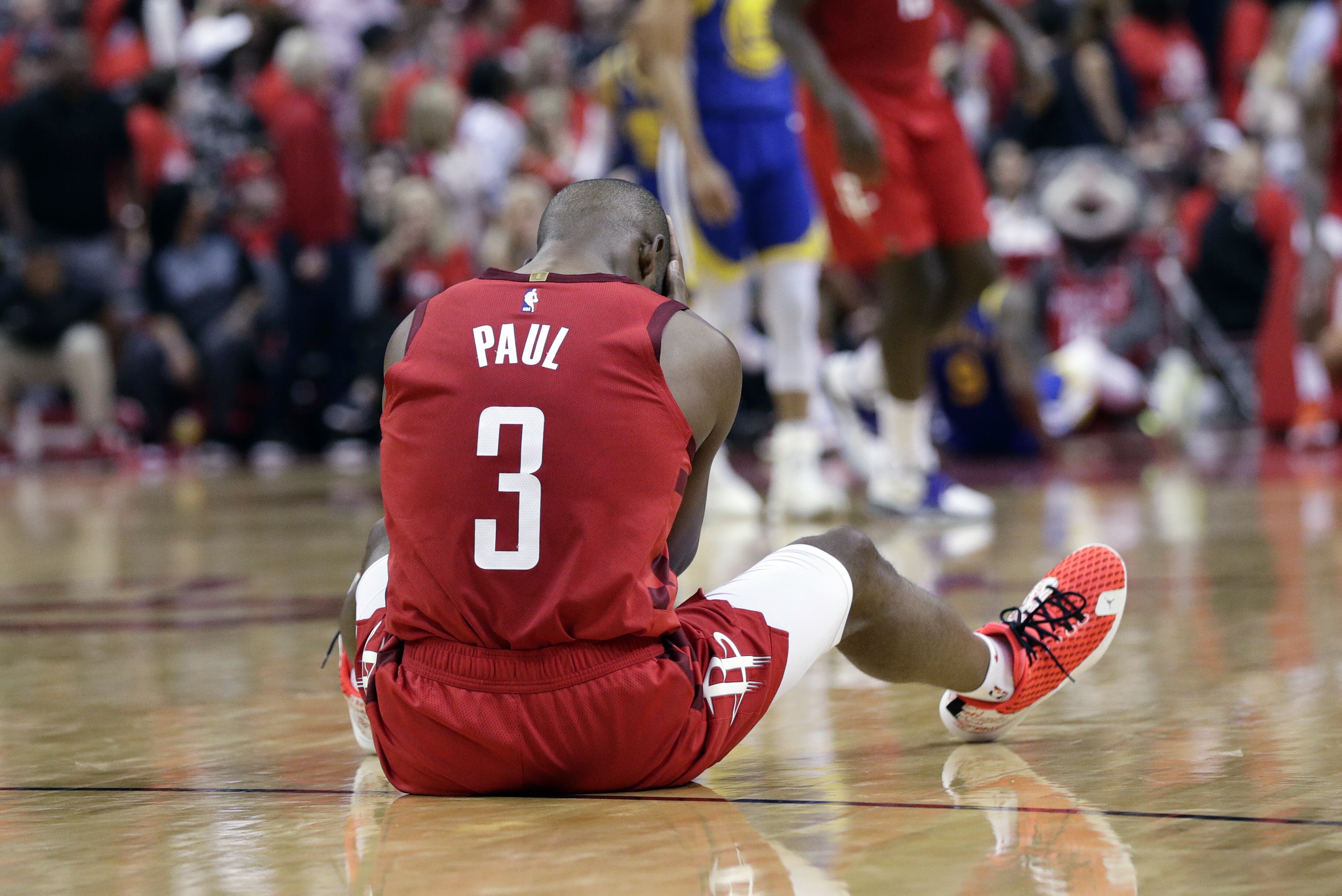 Houston Rockets guard Chris Paul sits on the court following a play during the second half in Game 6 of the team's second-round NBA basketball playoff series against the Golden State Warriors, Friday, May 10, 2019, in Houston. Golden State won 118-113, winning the series. (AP Photo/Eric Gay)