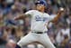 Los Angeles Dodgers starting pitcher Julio Urias works against the Colorado Rockies during the first inning of a baseball game Sunday, April 7, 2019, in Denver. (AP Photo/David Zalubowski)