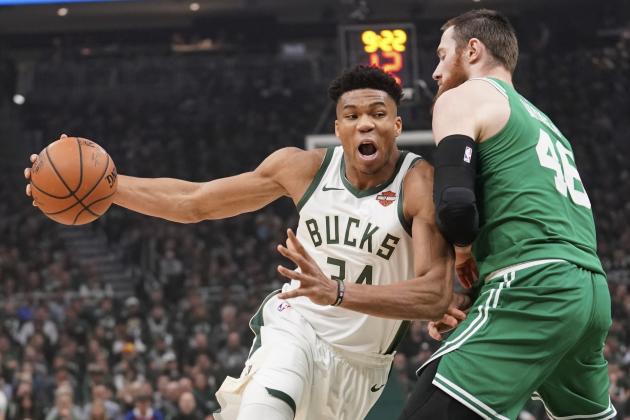 File-This May 8, 2019, file photo shows Milwaukee Bucks' Giannis Antetokounmpo driving past Boston Celtics' Aron Baynes during the first half of Game 5 of a second round NBA basketball playoff series in Milwaukee. Leading the Bucks’ resurgence is MVP candidate Antetokounmpo, a fan favorite and a source of pride for Milwaukee’s Greek community. Antetokounmpo was born in Athens, Greece.“It’s important for the Greek community to be able to gather together as a unit and celebrate him. And he in turn celebrates us,” said Tim Stasinoulias, 61, a Bucks fan since the team came to Milwaukee in 1968.(AP Photo/Morry Gash, File)