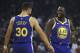 Golden State Warriors' Draymond Green, right, greets Stephen Curry (30) prior to the first half of an NBA basketball game against the Minnesota Timberwolves Monday, Dec. 10, 2018, in Oakland, Calif. The first game both have retuned to play at home since recovering from injuries. (AP Photo/Ben Margot)
