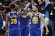 Golden State Warriors guard Stephen Curry, right, greets Alfonzo McKinnie (28) and Kevon Looney, center, during the second half of Game 3 of the team's NBA basketball playoffs Western Conference finals against the Portland Trail Blazers, Saturday, May 18, 2019, in Portland, Ore. The Warriors won 110-99. (AP Photo/Ted S. Warren)