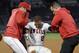 Los Angeles Angels' Andrelton Simmons, center, is helped up by manager Brad Ausmus, left, and a trainer after he was injured while being thrown out at first during the eighth inning of a baseball game against the Minnesota Twins Monday, May 20, 2019, in Anaheim, Calif. (AP Photo/Mark J. Terrill)
