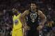 Milwaukee Bucks' Giannis Antetokounmpo (34) stands in front of Golden State Warriors' Kevin Durant during the first half of an NBA basketball game Thursday, March 29, 2018, in Oakland, Calif. (AP Photo/Marcio Jose Sanchez)