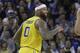 Golden State Warriors center DeMarcus Cousins smiles after scoring against the Denver Nuggets during an NBA basketball game in Oakland, Calif., Tuesday, April 2, 2019. (AP Photo/Jeff Chiu)