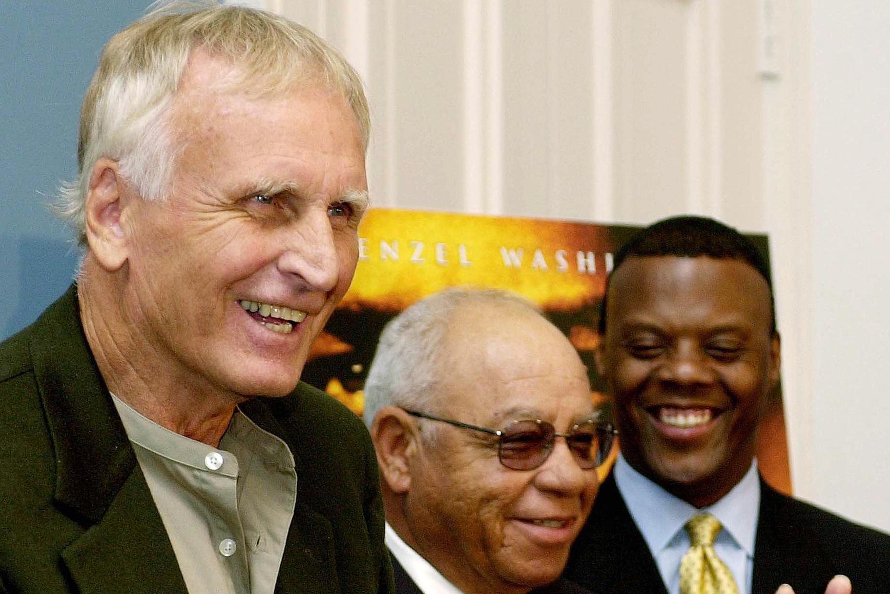 WASHINGTON, :  US Rep. J.C, Watts, Jr (R-OK) (R) looks on as former Alexandria, Virginia high school foootball coaches Bill Yoast (L) and Herman Boone (C) discuss the Walt Disney Company's latest film