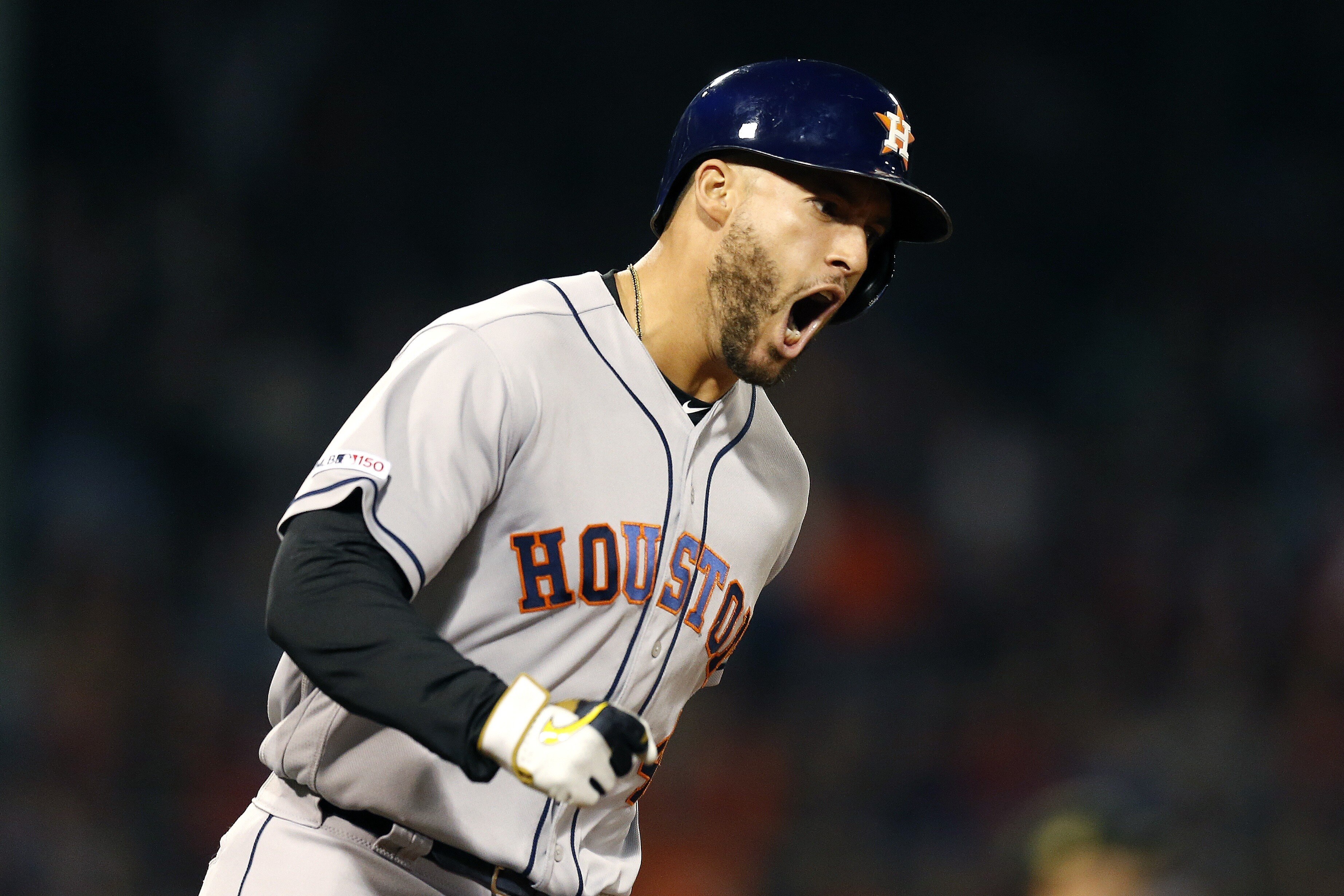 Houston Astros' George Springer reacts after hitting a two-run home run during the eighth inning of the team's baseball game against the Boston Red Sox in Boston, Friday, May 17, 2019. (AP Photo/Michael Dwyer)