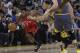 Toronto Raptors guard Kyle Lowry (7) drives to the basket against Golden State Warriors' Stephen Curry during the first half of an NBA basketball game in Oakland, Calif., Wednesday, Dec. 12, 2018. (AP Photo/Jeff Chiu)