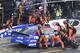 Crew members lift Martin Truex Jr.'s car to change a flat tire during a NASCAR Cup Series auto race at Charlotte Motor Speedway in Concord, N.C., Sunday, May 26, 2019. (AP Photo/Mike McCarn)