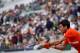 Serbia's Novak Djokovic plays a backhand return to Switzerland's Henri Laaksonen during their men's singles second round match on day five of The Roland Garros 2019 French Open tennis tournament in Paris on May 30, 2019. (Photo by Kenzo TRIBOUILLARD / AFP) (Photo credit should read KENZO TRIBOUILLARD/AFP/Getty Images)