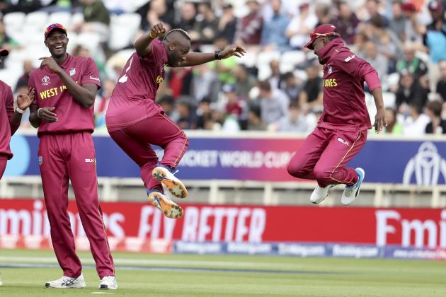 West Indies' bowler Andre Russell, second from right, celebrates with Darren Bravo taking the wicket of Pakistan's Haris Sohail as West Indies' captain Jason Holder, left, smiles during a Cricket World Cup match at Trent Bridge cricket ground in Nottingham, England, Friday, May 31, 2019. (AP Photo/Rui Vieira)