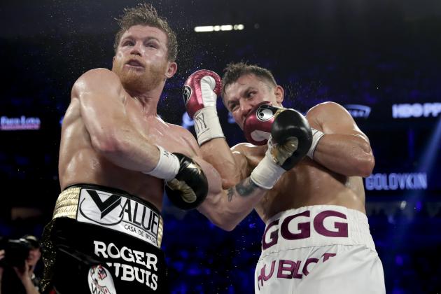 Canelo Alvarez, left, and Gennady Golovkin trade punches in the fourth round during a middleweight title boxing match, Saturday, Sept. 15, 2018, in Las Vegas. (AP Photo/Isaac Brekken)