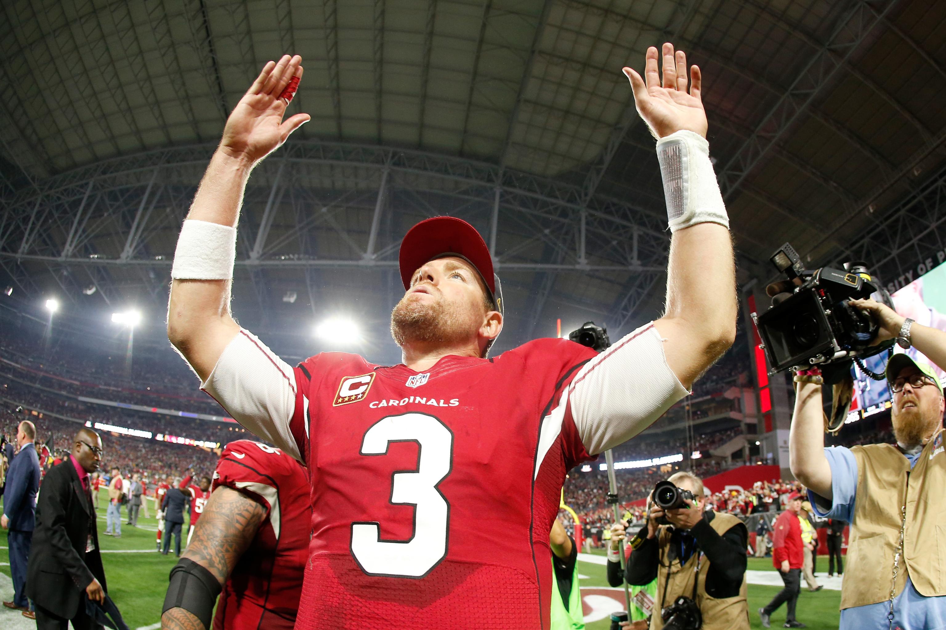 Former Arizona Cardinals quarterback Carson Palmer stands with his family  as team president Michael Bidwill speaks after being added to the Cardinals  ring of honor at half time of an NFL football