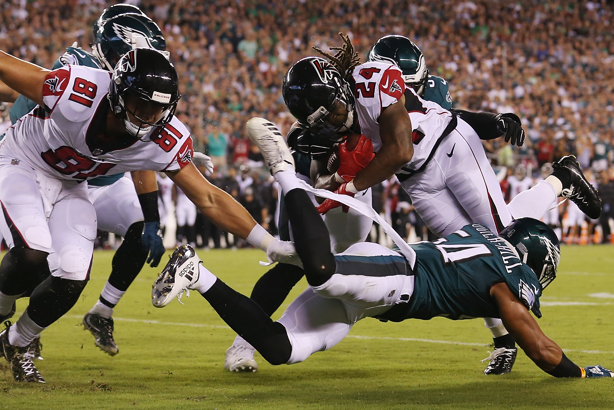 Warrick Dunn of the Atlanta Falcons runs with the ball while pursued