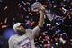 New England Patriots' Julian Edelman holds the Vince Lombardi Trophy, after the NFL Super Bowl 53 football game against the Los Angeles Rams, Sunday, Feb. 3, 2019, in Atlanta. The Patriots won 13-3. Edelman was named the Most Valuable Player. (AP Photo/Jeff Roberson)