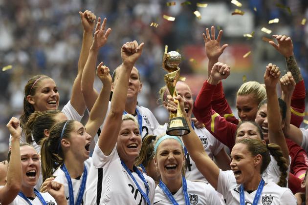 USA teammates hold the trophy following the teams' win in the final 2015 FIFA Women's World Cup match between USA and Japan at the BC Place Stadium in Vancouver on July 5, 2015.  AFP PHOTO / FRANCK FIFE (Photo by FRANCK FIFE / AFP)        (Photo credit should read FRANCK FIFE/AFP/Getty Images)