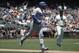 Los Angeles Dodgers' Max Muncy, left, gestures while running up the during the first inning of line after hitting a solo home run off of San Francisco Giants pitcher Madison Bumgarner, right, during the first inning of a baseball game in San Francisco, Sunday, June 9, 2019. (AP Photo/Jeff Chiu)