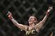 FILE - In this Sept. 25, 2016, file photo, Brazil's Cris “Cyborg” Justino celebrates after defeating Sweden's Lina Lansberg during a UFC Fight Night mixed martial arts bout in Brasilia, Brazil. Justino agreed to make a title defense against Yana Kunitskaya, of Russia, on short notice in the headlining bout at UFC 222 because she believes champions should be willing to fight anywhere at any time. (AP Photo/Eraldo Peres, File)
