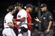 BOSTON, MA - JUNE 11: Manager Alex Cora of the Boston Red Sox argues with first base umpire Vic Carapazza as first base coach Tom Goodwin holds back Andrew Benintendi #16 after Benintendi was ejected during the sixth inning of a game against the Texas Rangers on June 11, 2019 at Fenway Park in Boston, Massachusetts. (Photo by Billie Weiss/Boston Red Sox/Getty Images)