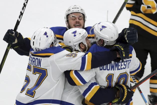 St. Louis Blues' Ryan O'Reilly, center, celebrates his goal with teammates Alex Pietrangelo, left, Sammy Blais, rear, and Jay Bouwmeester, right, during the first period in Game 7 of the NHL hockey Stanley Cup Final against the Boston Bruins, Wednesday, June 12, 2019, in Boston. (AP Photo/Charles Krupa)
