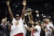 Toronto Raptors center Serge Ibaka, left, guard Kyle Lowry, center, and guard Danny Green celebrate with teammates after the Raptors defeated the Golden State Warriors in Game 6 of basketball's NBA Finals in Oakland, Calif., Thursday, June 13, 2019. (AP Photo/Ben Margot)