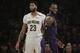 Los Angeles Lakers' LeBron James, right, smiles as he walks past New Orleans Pelicans' Anthony Davis during the first half of an NBA basketball game, Friday, Dec. 21, 2018, in Los Angeles. (AP Photo/Jae C. Hong)