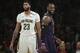 Los Angeles Lakers' LeBron James, right, smiles as he walks past New Orleans Pelicans' Anthony Davis during the first half of an NBA basketball game Friday, Dec. 21, 2018, in Los Angeles. (AP Photo/Jae C. Hong)