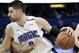 Toronto Raptors' Kyle Lowry's arm, left, reaches in to try to stop Orlando Magic's Nikola Vucevic for getting to the basket during the second half in Game 3 of a first-round NBA basketball playoff series, Friday, April 19, 2019, in Orlando, Fla. (AP Photo/John Raoux)