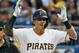 Pittsburgh Pirates' Kevin Newman celebrates as he stands on first base after driving in two runs with a single off Milwaukee Brewers relief pitcher Freddy Peralta during the third inning of a baseball game in Pittsburgh, Friday, May 31, 2019. (AP Photo/Gene J. Puskar)