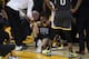 Golden State Warriors guard Klay Thompson, center, is helped up after being injured during the second half of Game 6 of basketball's NBA Finals against the Toronto Raptors in Oakland, Calif., Thursday, June 13, 2019. (AP Photo/Tony Avelar)