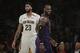 Los Angeles Lakers' LeBron James, right, smiles as he walks past New Orleans Pelicans' Anthony Davis during the first half of an NBA basketball game, Friday, Dec. 21, 2018, in Los Angeles. (AP Photo/Jae C. Hong)