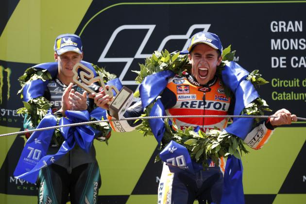 MotoGP Honda rider Marc Marquez of Spain, right, celebrates after winning the Catalunya Motorcycle Grand Prix as 2nd placed Fabio Quartararo of France applauds at the Barcelona Catalunya racetrack in Montmelo, near Barcelona, Spain, on Sunday June 16, 2019. (AP Photo/Joan Monfort)