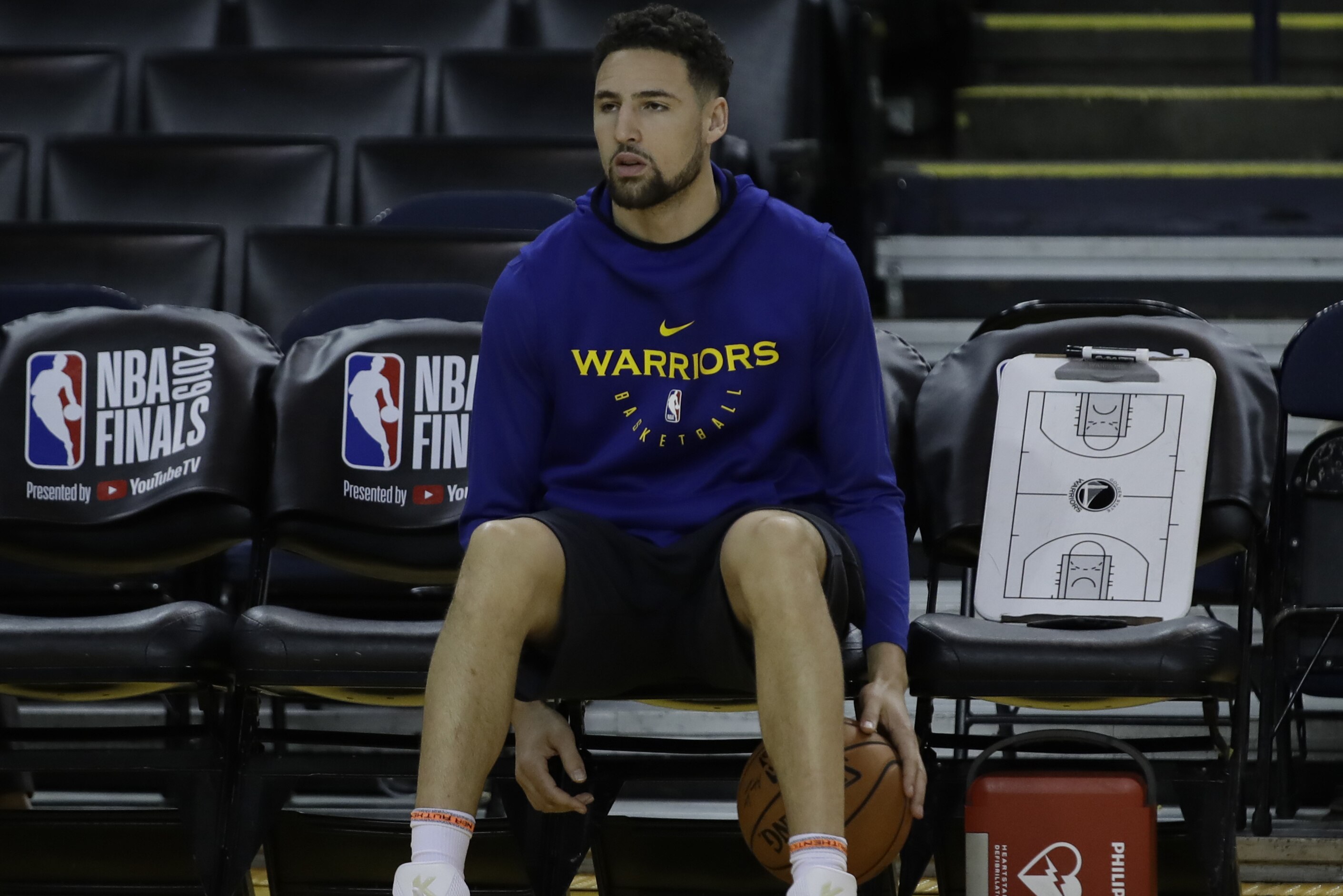 Golden State Warriors' Klay Thompson sits on the bench during practice for the NBA Finals against the Toronto Raptors Tuesday, June 4, 2019, in Oakland, Calif. Game 3 of the NBA Finals is Wednesday, June 5, 2019 in Oakland, Calif. (AP Photo/Ben Margot)