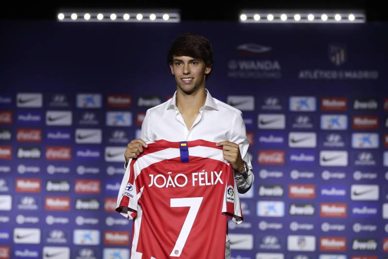 Atletico Madrid's new signing soccer player Joao Felix holds his new jersey as he poses for media during his official presentation at the Wanda Metropolitano Stadium in Madrid, Monday, July. 8, 2019. Atletico Madrid has reached a deal to sign Joao Felix and will sign a seven-year contract. (AP Photo/Manu Fernandez)