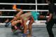 Thailand's Jo Nattawut, right, floors opponent Giorgio Petrosyan, of Italy, during their ONE Championship kickboxing bout Friday, April 20, 2018, at Mall of Asia Arena in suburban Pasay city south of Manila, Philippines. ONE Championship, Asia's premier martial arts organization, introduced the new ring instead of the octagon cage. Petrosyan won the bout via unanimous decision. (AP Photo/Bullit Marquez)