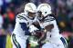 FOXBOROUGH, MASSACHUSETTS - JANUARY 13: Philip Rivers #17 of the Los Angeles Chargers hands off the ball to Melvin Gordon #28 during the second quarter in the AFC Divisional Playoff Game against the New England Patriots at Gillette Stadium on January 13, 2019 in Foxborough, Massachusetts. (Photo by Adam Glanzman/Getty Images)